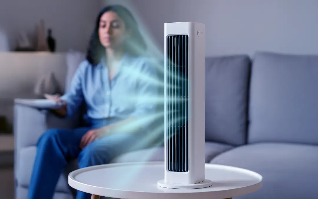 Woman enjoying Qinux BreezaMax Portable AC Cooling